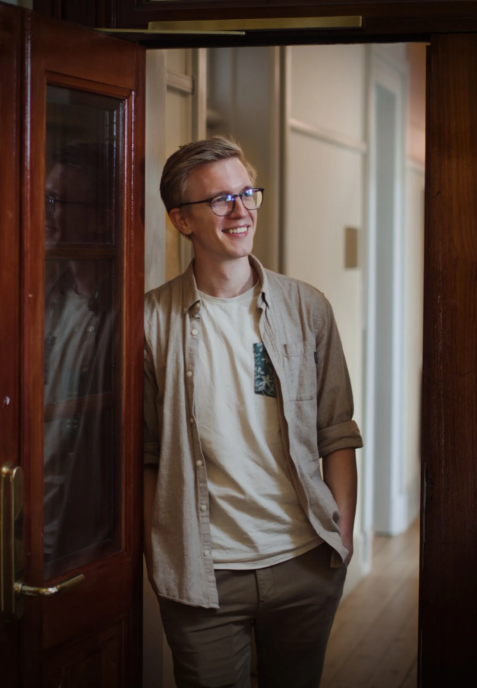 Christoffer leaning against the office door